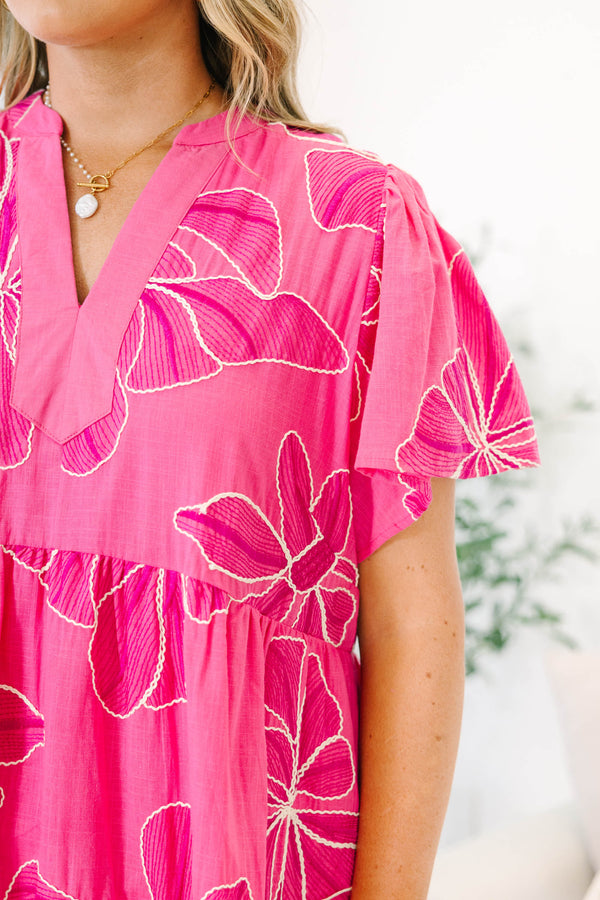 Plus Size pink midi dress with white floral embroidery, V-neckline, and short flutter sleeves.