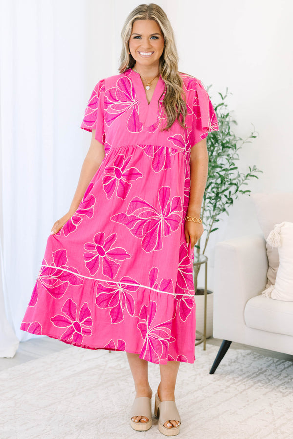Plus Size pink midi dress with white floral embroidery, V-neckline, and short flutter sleeves.