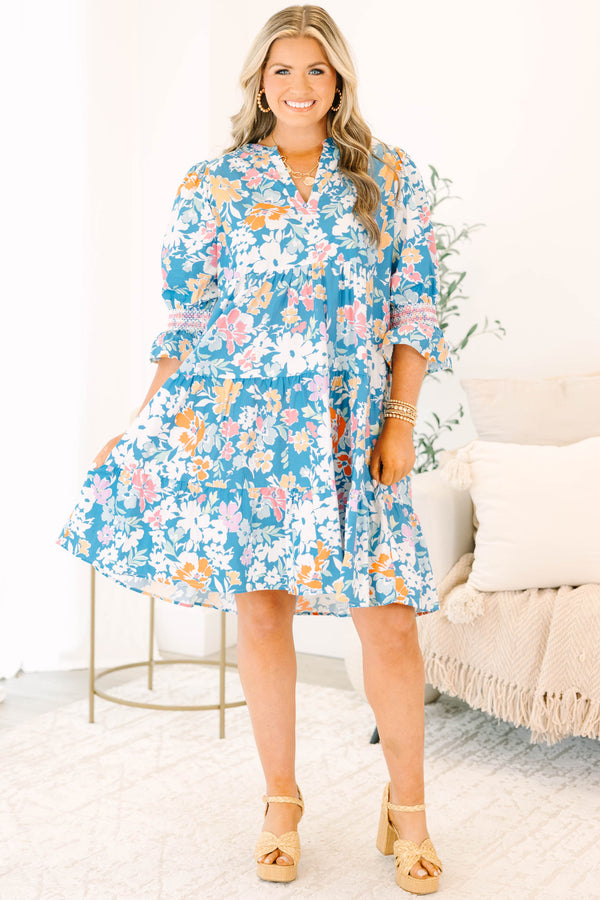 Plus size blue floral mix dress with a flowy tiered silhouette, V-neckline, and ruffle sleeves.