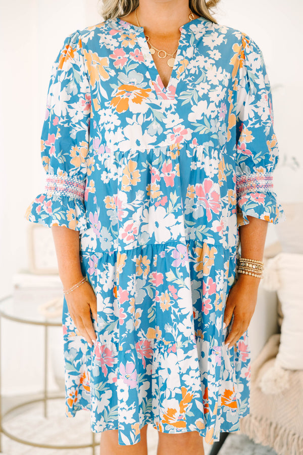 Plus size blue floral mix dress with a flowy tiered silhouette, V-neckline, and ruffle sleeves.
