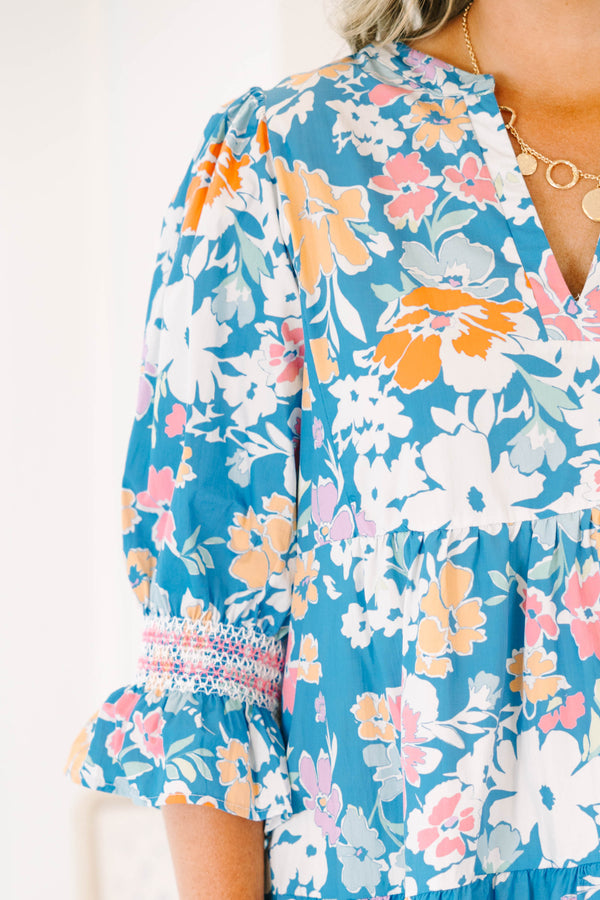 Plus size blue floral mix dress with a flowy tiered silhouette, V-neckline, and ruffle sleeves.