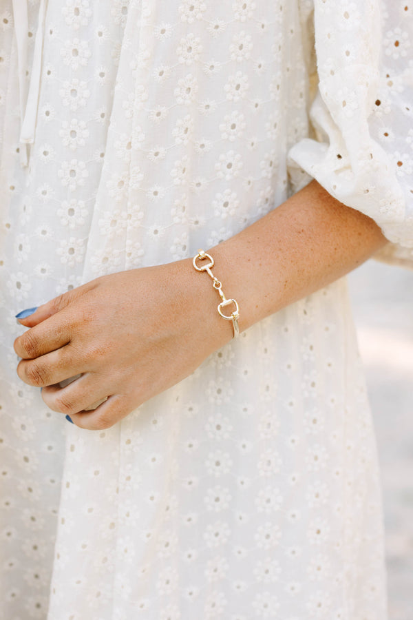 Plus Size gold horse bit style bangle bracelet worn with a white eyelet lace top.
