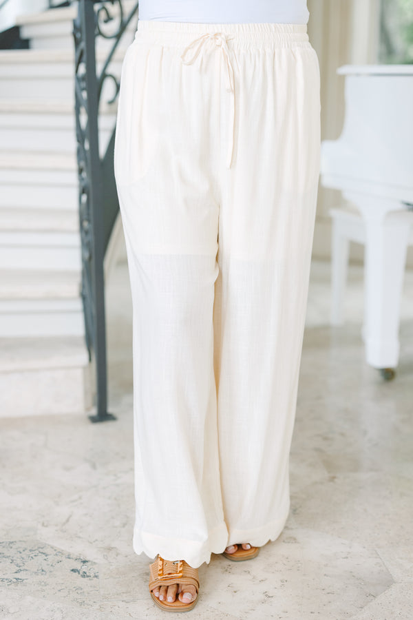 Plus Size white linen wide-leg pants with an elastic drawstring waist and scalloped hem.