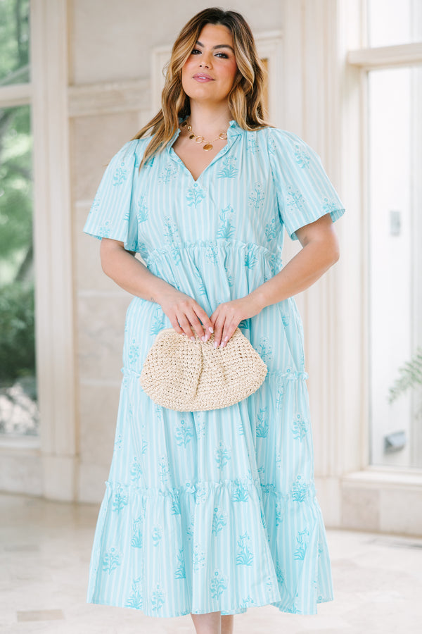 Light blue tiered midi dress with a split v-neck, vertical stripes, and a floral print.