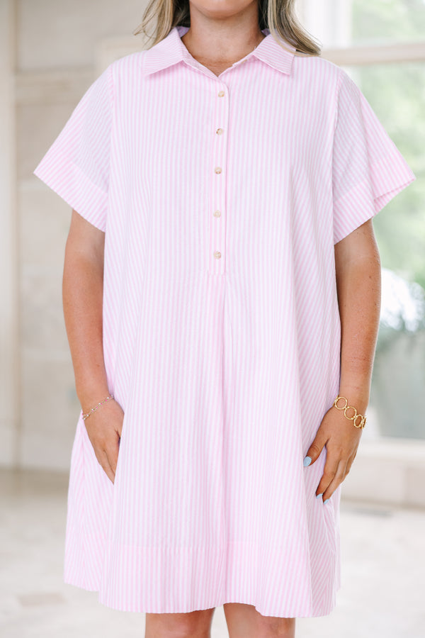Plus size pink and white striped A-line shirt dress with a collared neckline and short sleeves.