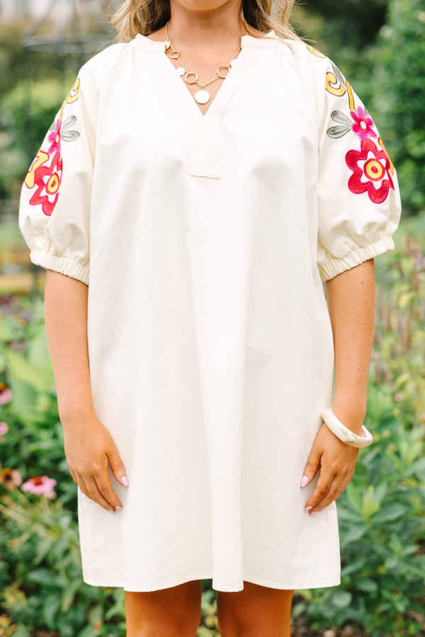 Plus Size cream cotton dress with a V-neckline and puff sleeves featuring colorful floral embroidery.