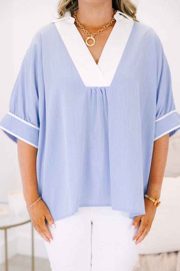 Plus Size light blue v-neck tunic top with white trim and short puff sleeves.