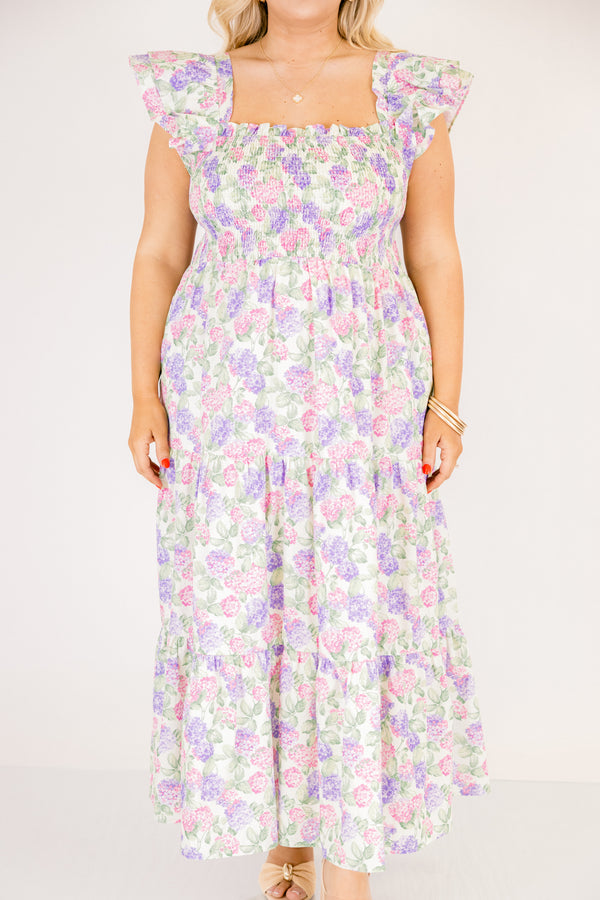 Chic Soul plus size clothing, pink and lilac tiered maxi dress with flutter sleeves as well as a smocked bust a square neckline and a hydrangea pattern throughout