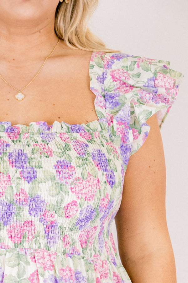 Chic Soul plus size clothing, pink and lilac tiered maxi dress with flutter sleeves as well as a smocked bust a square neckline and a hydrangea pattern throughout