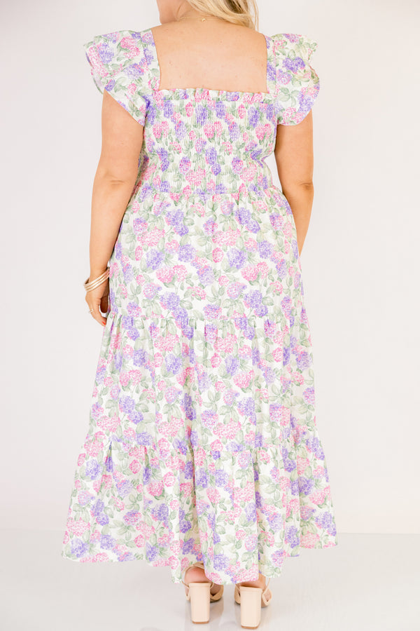 Chic Soul plus size clothing, pink and lilac tiered maxi dress with flutter sleeves as well as a smocked bust a square neckline and a hydrangea pattern throughout