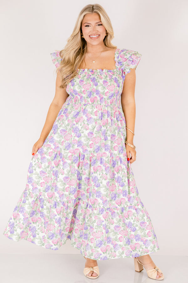 Chic Soul plus size clothing, pink and lilac tiered maxi dress with flutter sleeves as well as a smocked bust a square neckline and a hydrangea pattern throughout