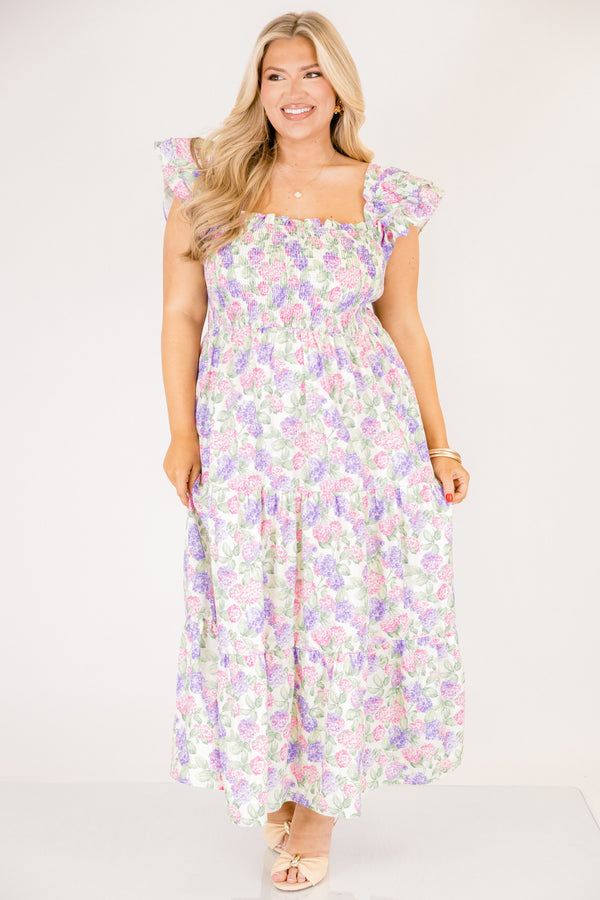 Chic Soul plus size clothing, pink and lilac tiered maxi dress with flutter sleeves as well as a smocked bust a square neckline and a hydrangea pattern throughout