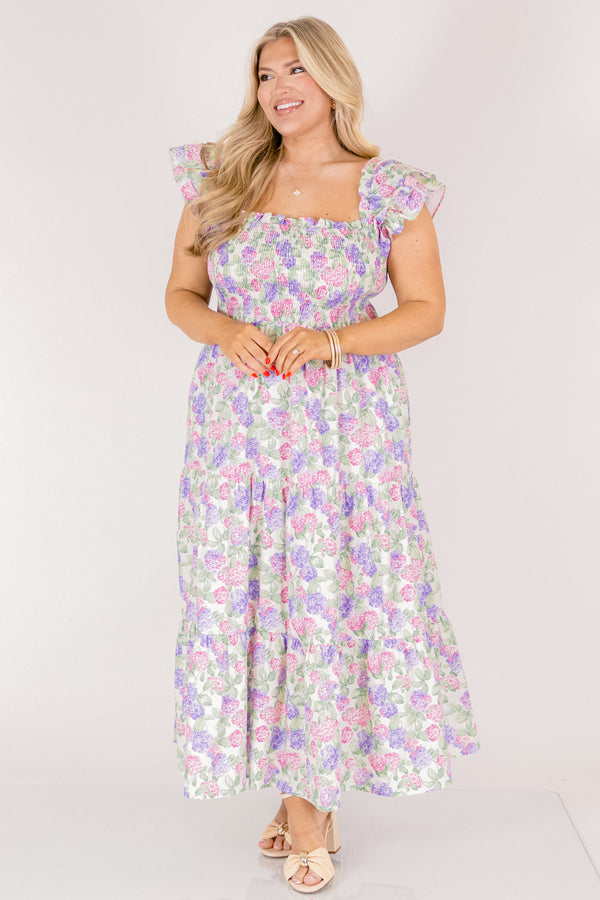 Chic Soul plus size clothing, pink and lilac tiered maxi dress with flutter sleeves as well as a smocked bust a square neckline and a hydrangea pattern throughout