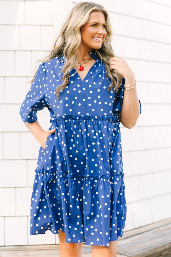 Plus Size navy blue polka dot tiered mini dress with short sleeves and a v-neckline.