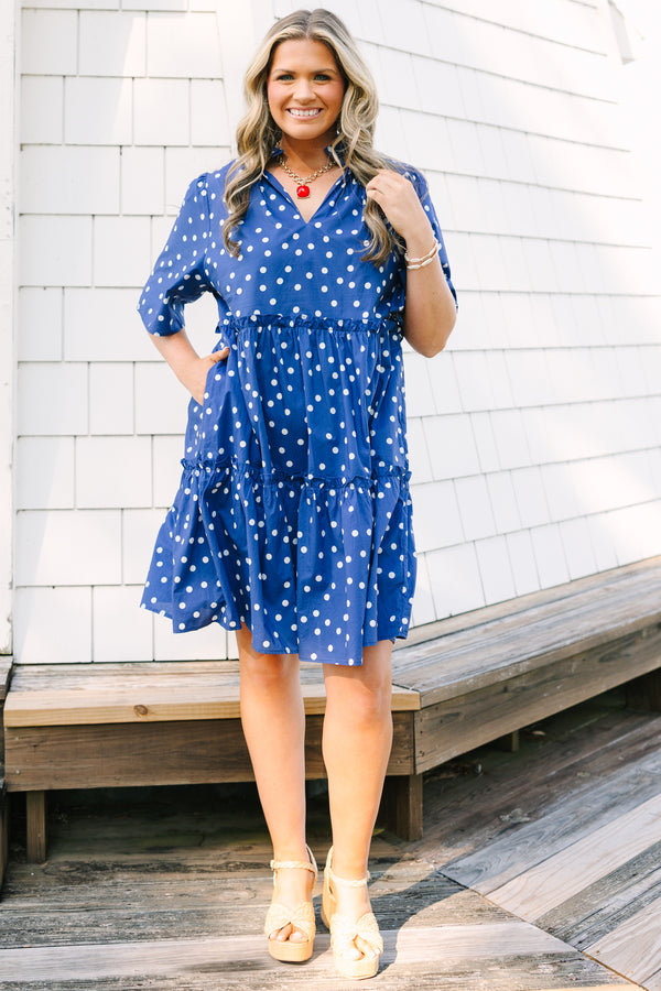 Plus Size navy blue polka dot tiered mini dress with short sleeves and a v-neckline.