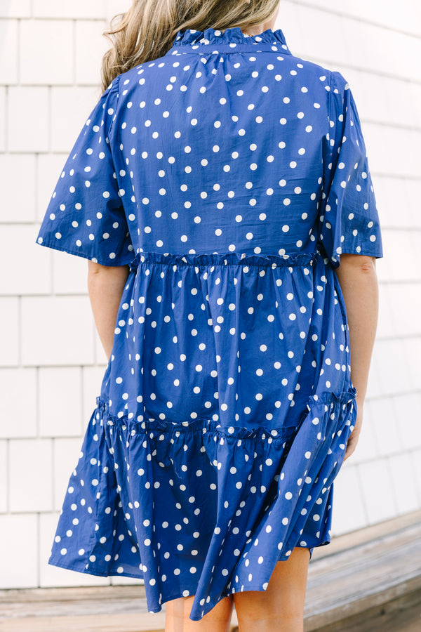 Plus Size navy blue polka dot tiered mini dress with short sleeves and a v-neckline.