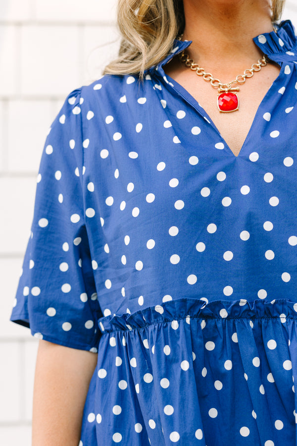 Plus Size navy blue polka dot tiered mini dress with short sleeves and a v-neckline.
