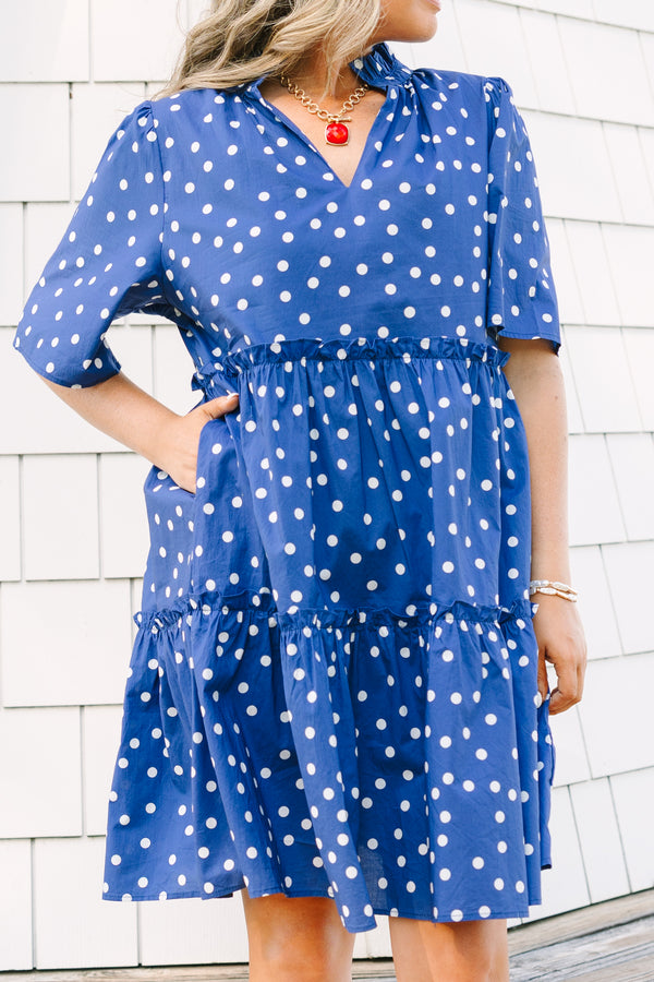 Plus Size navy blue polka dot tiered mini dress with short sleeves and a v-neckline.
