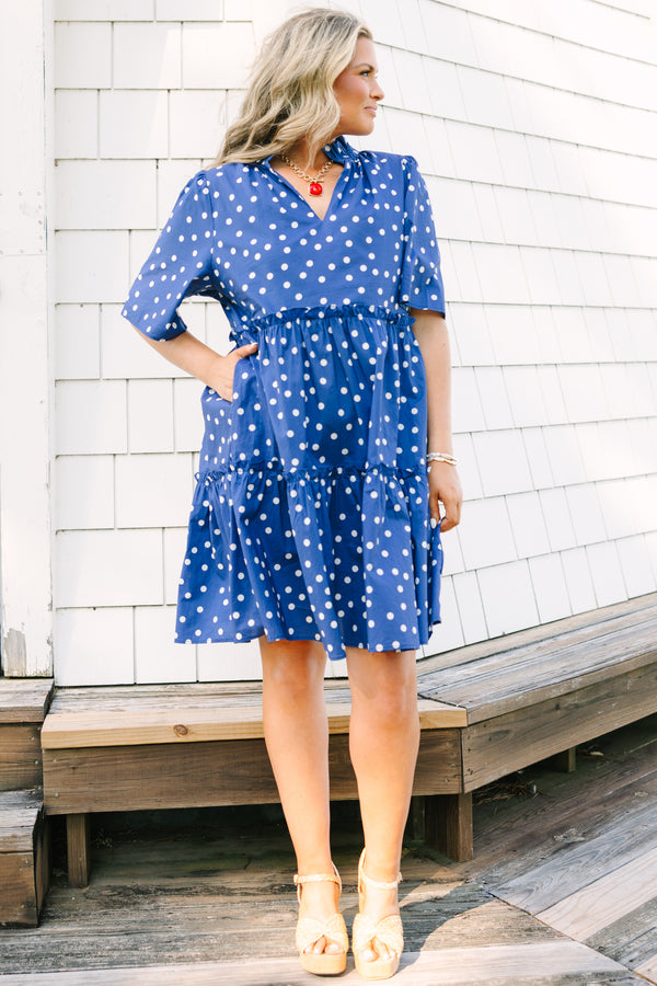 Plus Size navy blue polka dot tiered mini dress with short sleeves and a v-neckline.