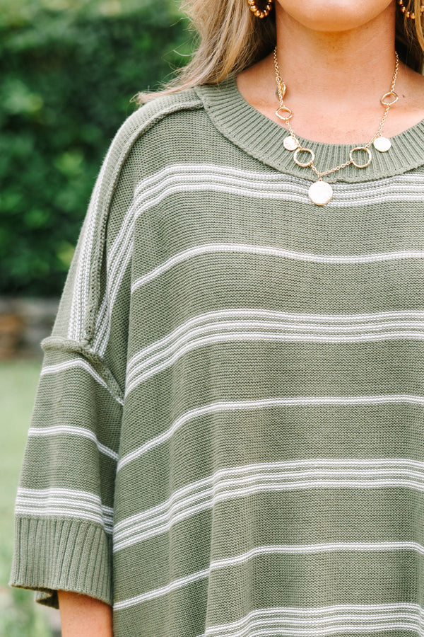 Plus Size olive green oversized knit sweater with white horizontal stripes and a crew neckline.