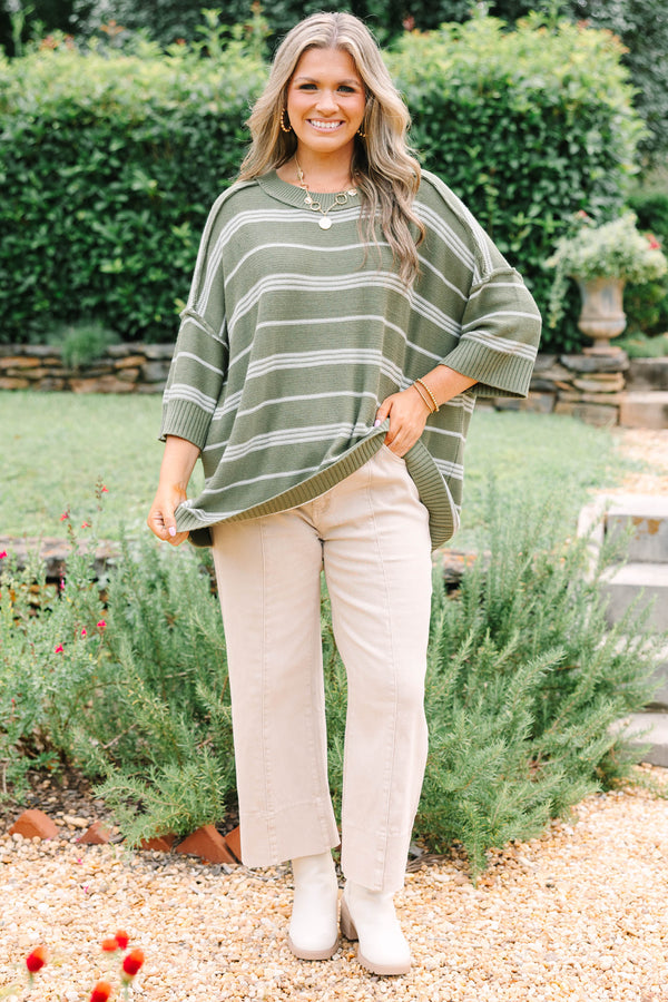 Plus Size olive green oversized knit sweater with white horizontal stripes and a crew neckline.