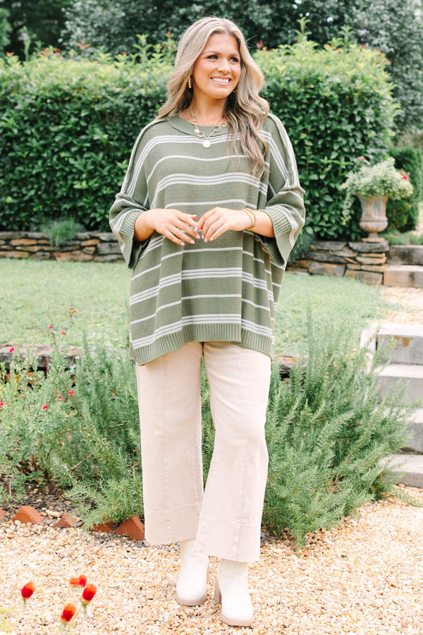 Plus Size olive green oversized knit sweater with white horizontal stripes and a crew neckline.