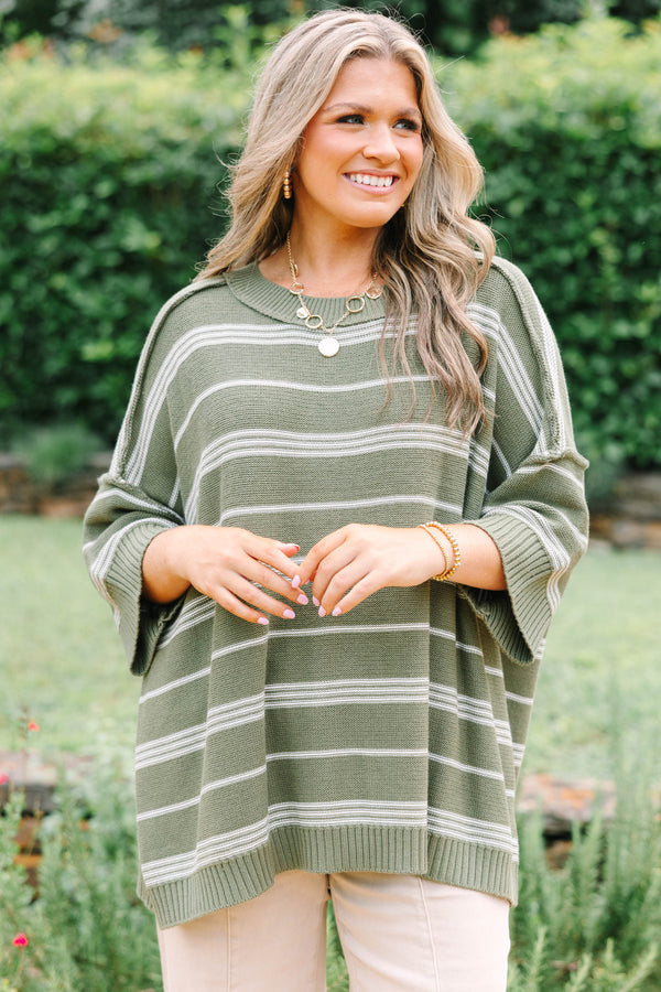 Plus Size olive green oversized knit sweater with white horizontal stripes and a crew neckline.