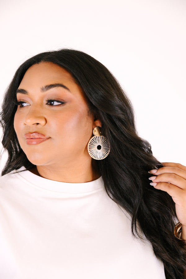 Chic Soul plus size clothing, gold statement earrings featuring a round stud top with a large circular drop design made of radiating white thread details, creating a sunburst pattern.