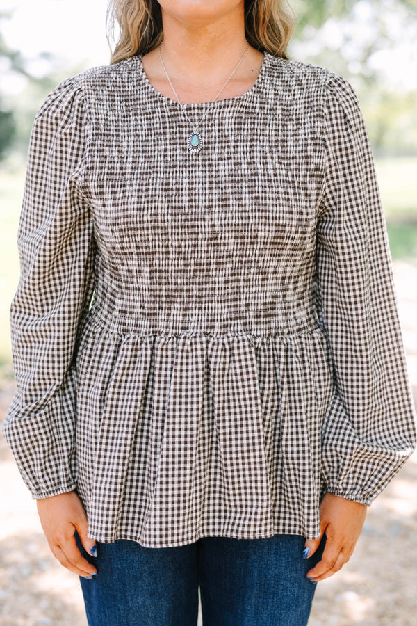 Plus Size brown gingham top with a smocked bodice, long sleeves, and a peplum hem.