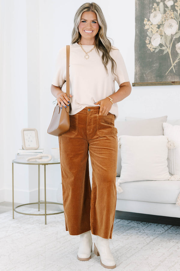 Plus Size brown corduroy wide-leg pants with front patch pockets and a raw hem.