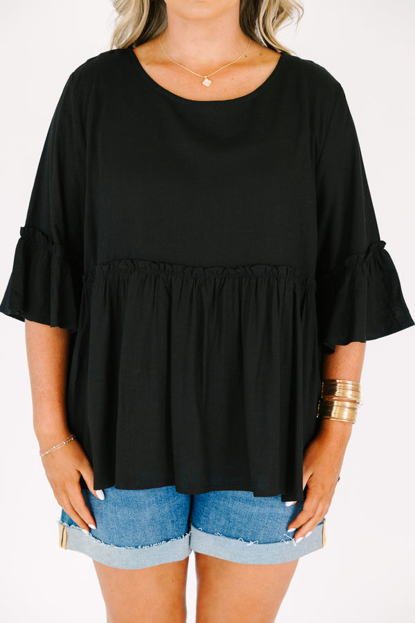 Plus Size black babydoll top with ruffled three-quarter sleeves and a round neckline.