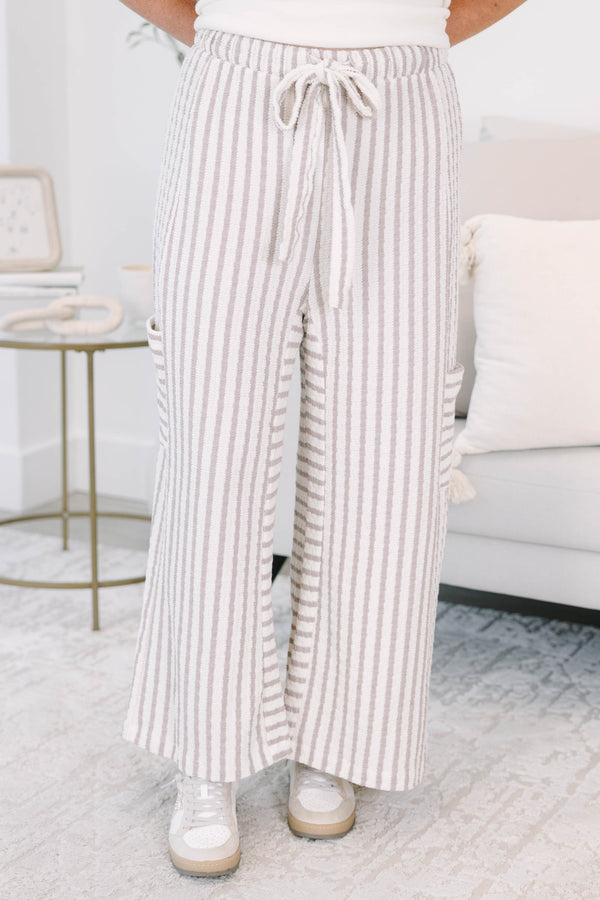 Striped wide leg pants with cream and white stripes with adjustable drawstring and pockets on either side