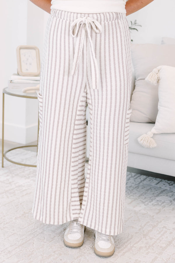 Striped wide leg pants with cream and white stripes with adjustable drawstring and pockets on either side