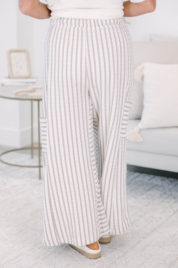 Striped wide leg pants with cream and white stripes with adjustable drawstring and pockets on either side