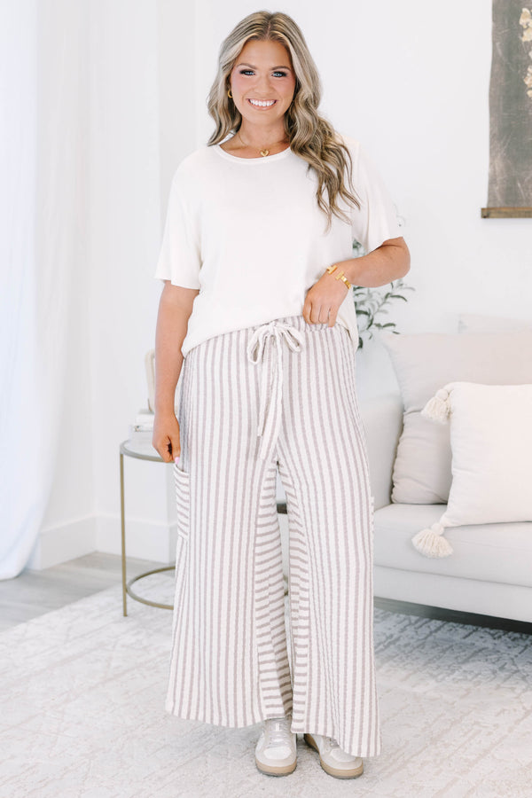 Striped wide leg pants with cream and white stripes with adjustable drawstring and pockets on either side