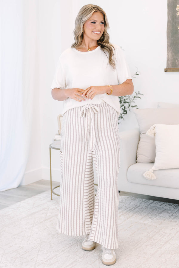 Striped wide leg pants with cream and white stripes with adjustable drawstring and pockets on either side