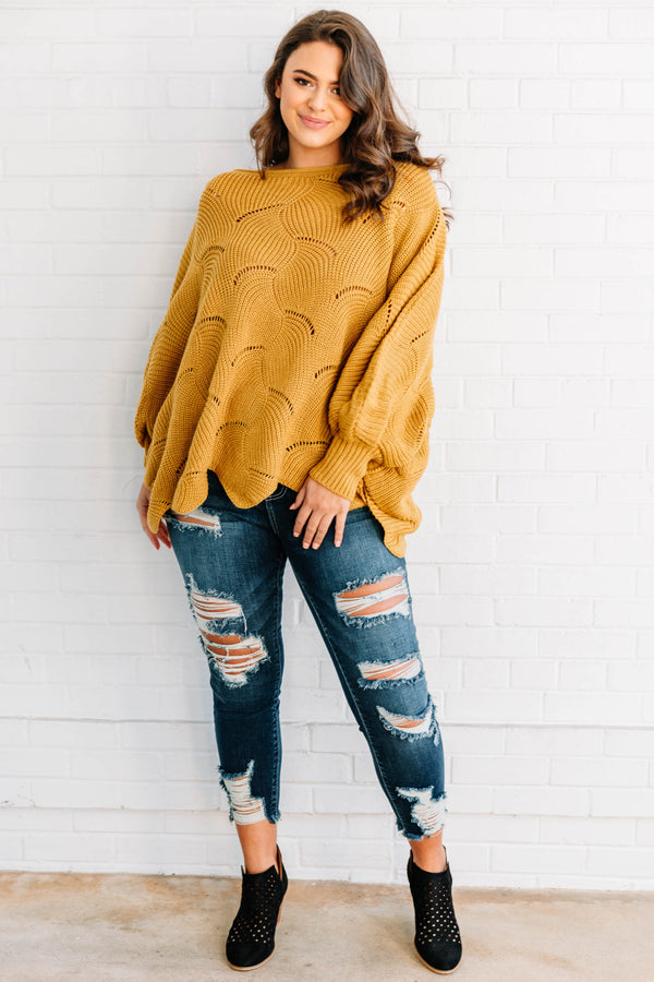 Plus Size mustard yellow poncho-style sweater with a textured wave pattern and dark wash jeans.
