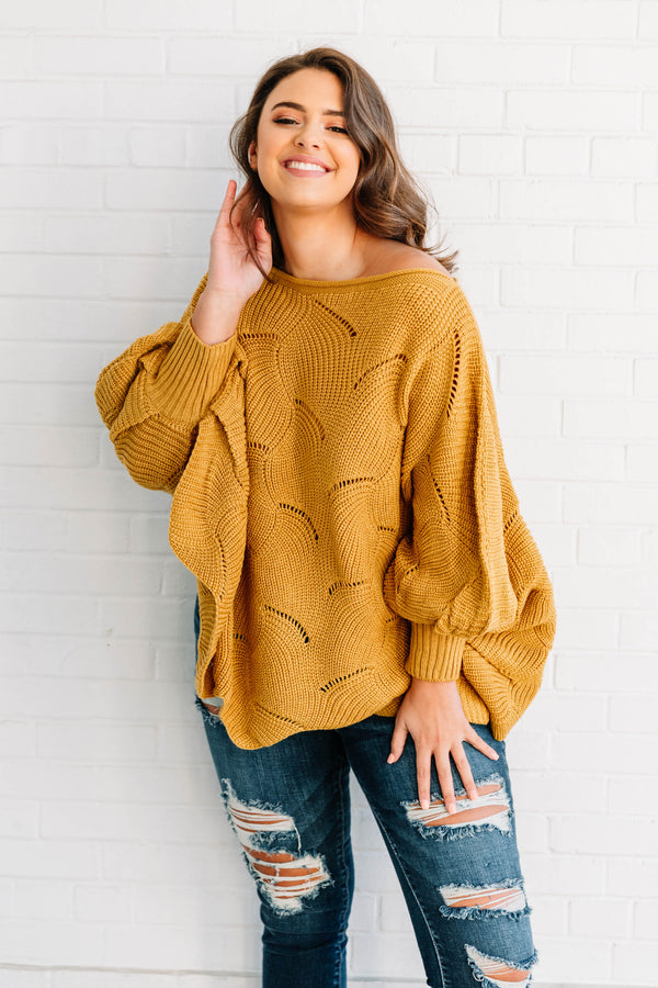 Plus Size mustard yellow poncho-style sweater with a textured wave pattern and dark wash jeans.