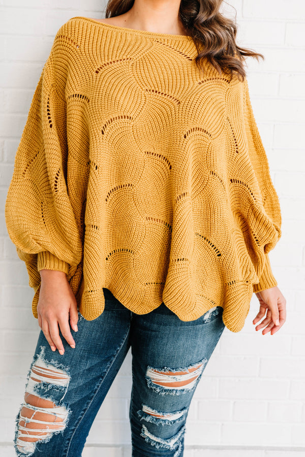 Plus Size mustard yellow poncho-style sweater with a textured wave pattern and dark wash jeans.