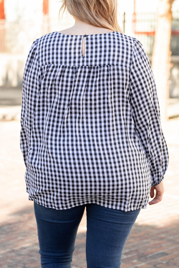 Plus Size black and white gingham top with a smocked neckline and long puff sleeves.