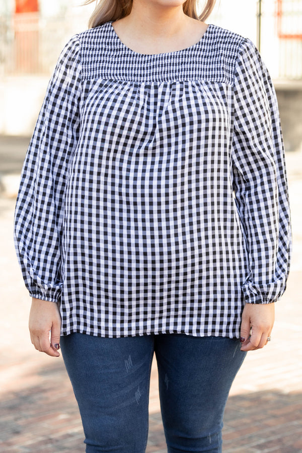 Plus Size black and white gingham top with a smocked neckline and long puff sleeves.