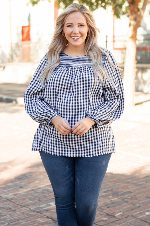 Plus Size black and white gingham top with a smocked neckline and long puff sleeves.