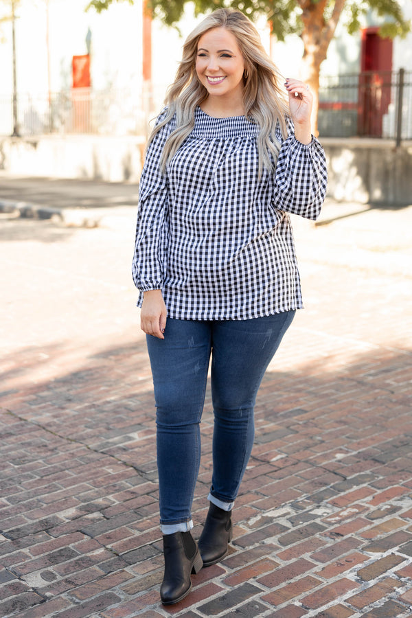 Plus Size black and white gingham top with a smocked neckline and long puff sleeves.