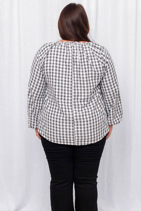 Plus Size charcoal and white gingham blouse with a gathered neckline and long puff sleeves.