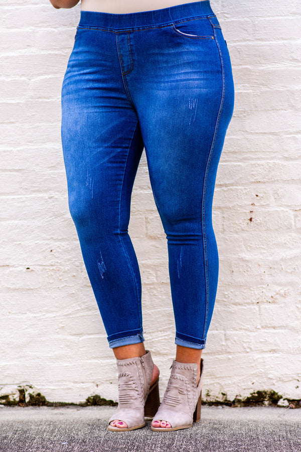 Plus Size medium wash jeggings with a stretchy high-rise waistband and distressed details.