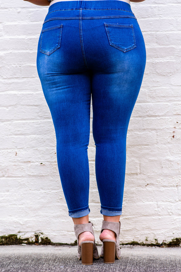 Plus Size medium wash jeggings with a stretchy high-rise waistband and distressed details.