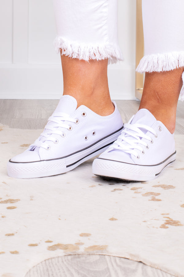 Plus Size white low-top canvas sneakers with white laces and a black stripe on the sole.
