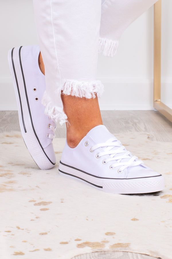 Plus Size white low-top canvas sneakers with white laces and a black stripe on the sole.