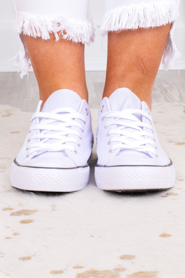 Plus Size white low-top canvas sneakers with white laces and a black stripe on the sole.
