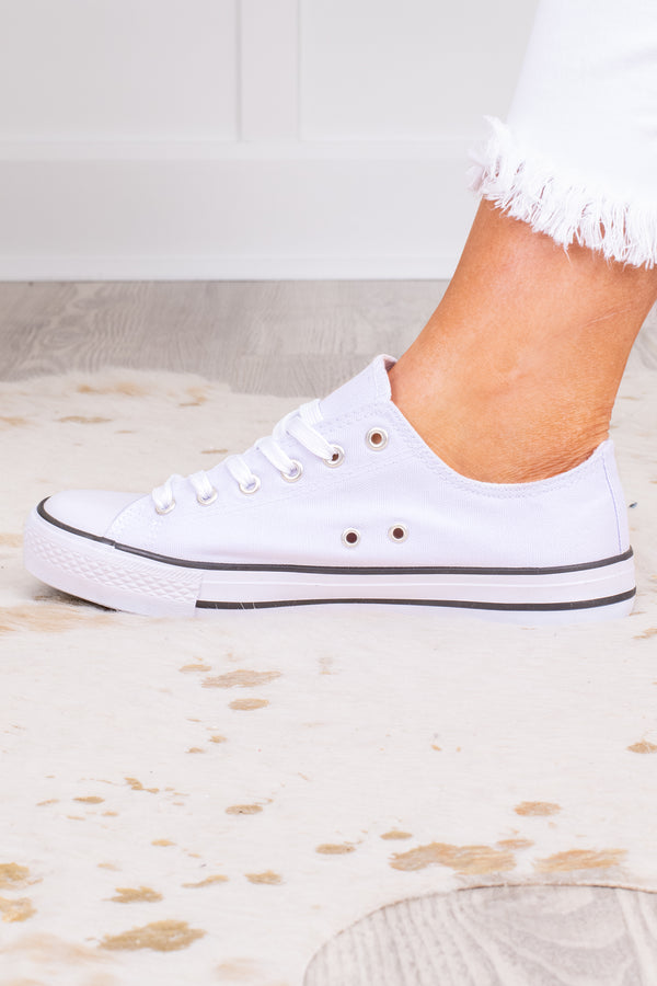 Plus Size white low-top canvas sneakers with white laces and a black stripe on the sole.